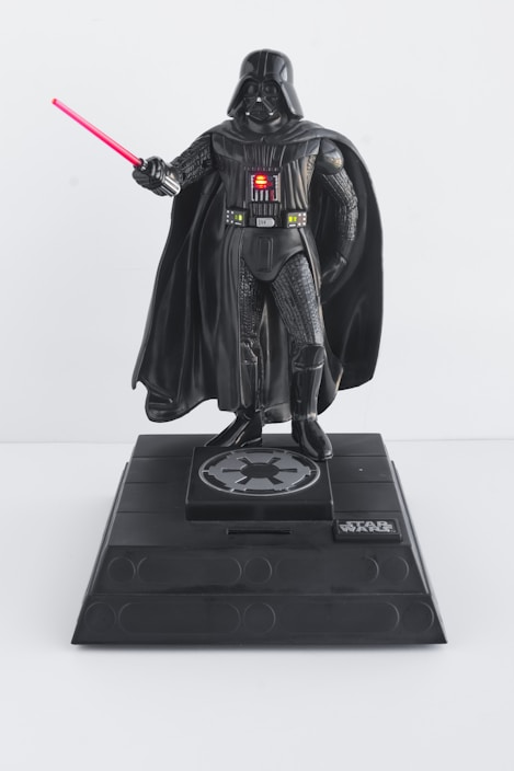 A detailed Star Wars action figure posed with a lightsaber in hand.
