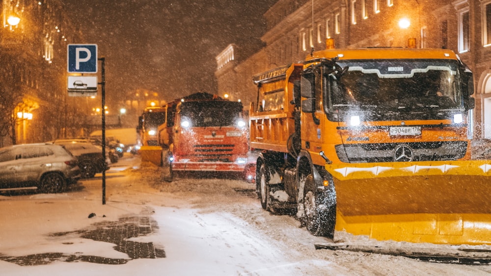 a snow plow is parked on a snowy street