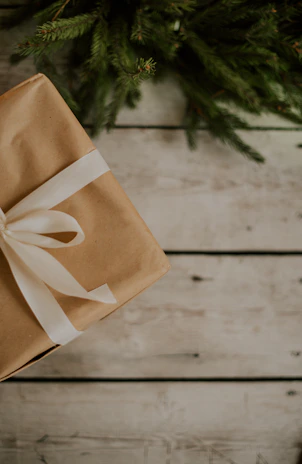 a wrapped present sitting on top of a wooden table