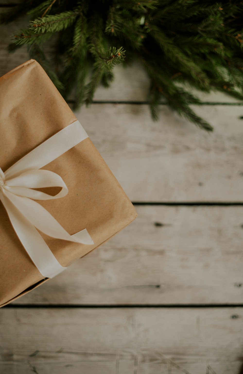 a wrapped present sitting on top of a wooden table