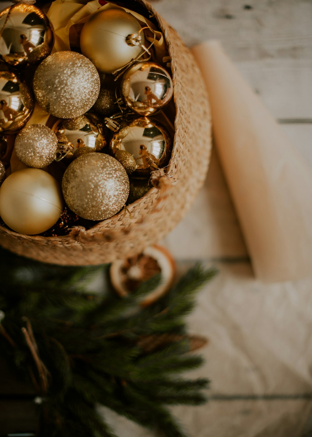 a basket filled with christmas ornaments on top of a table