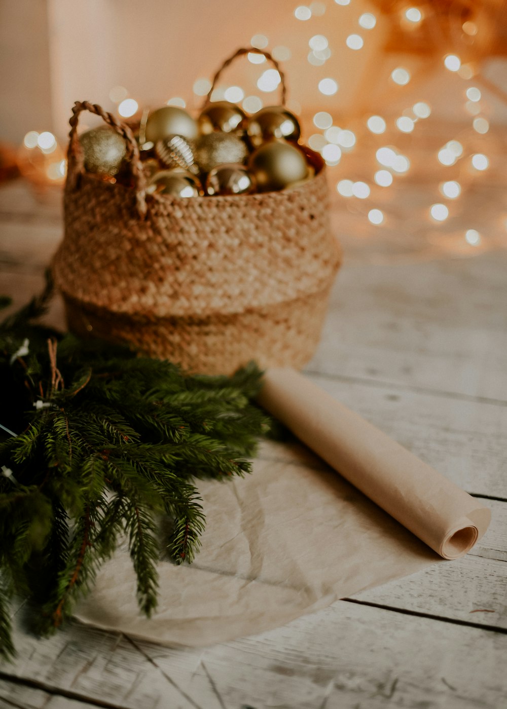 a basket filled with christmas ornaments on top of a wooden table