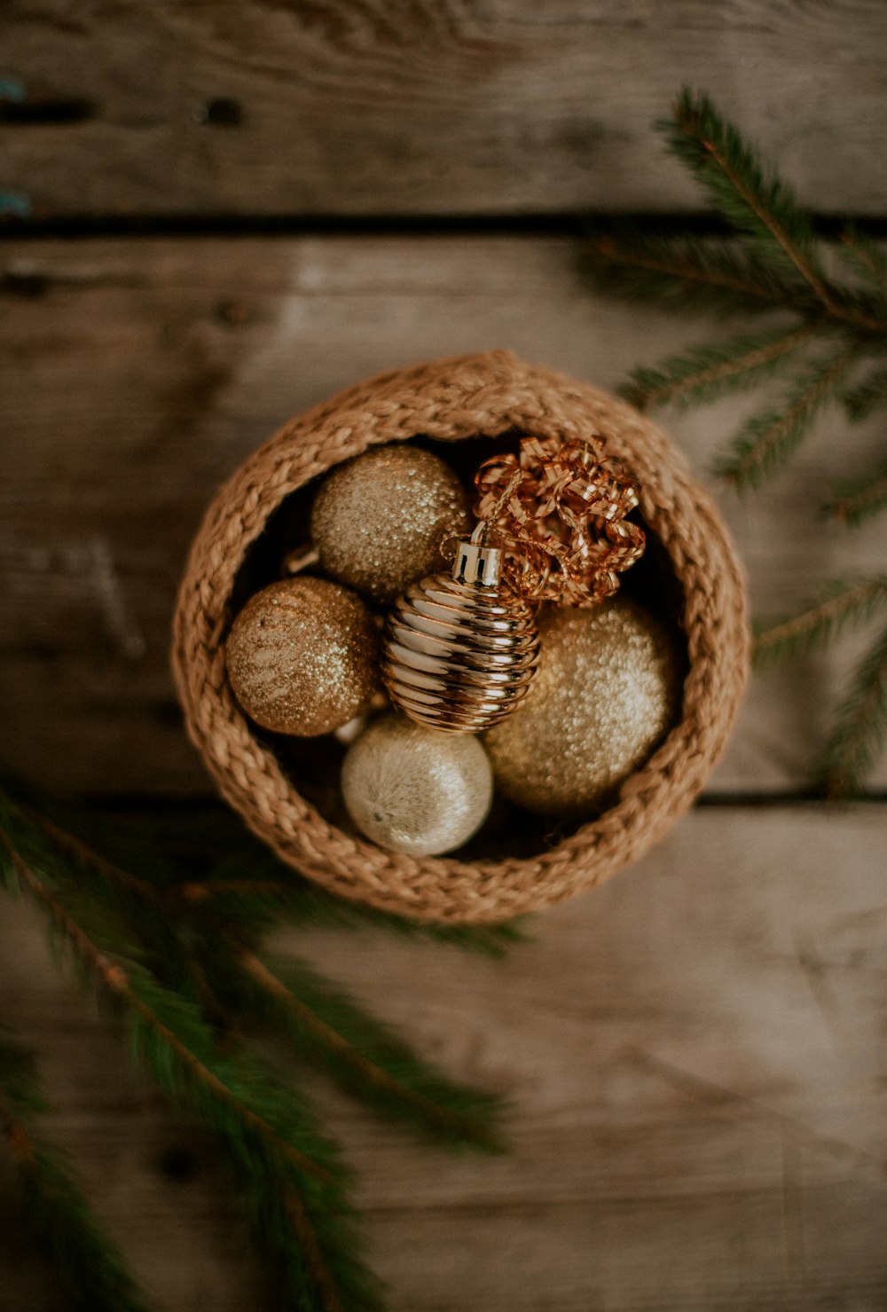a basket filled with christmas ornaments on top of a wooden table