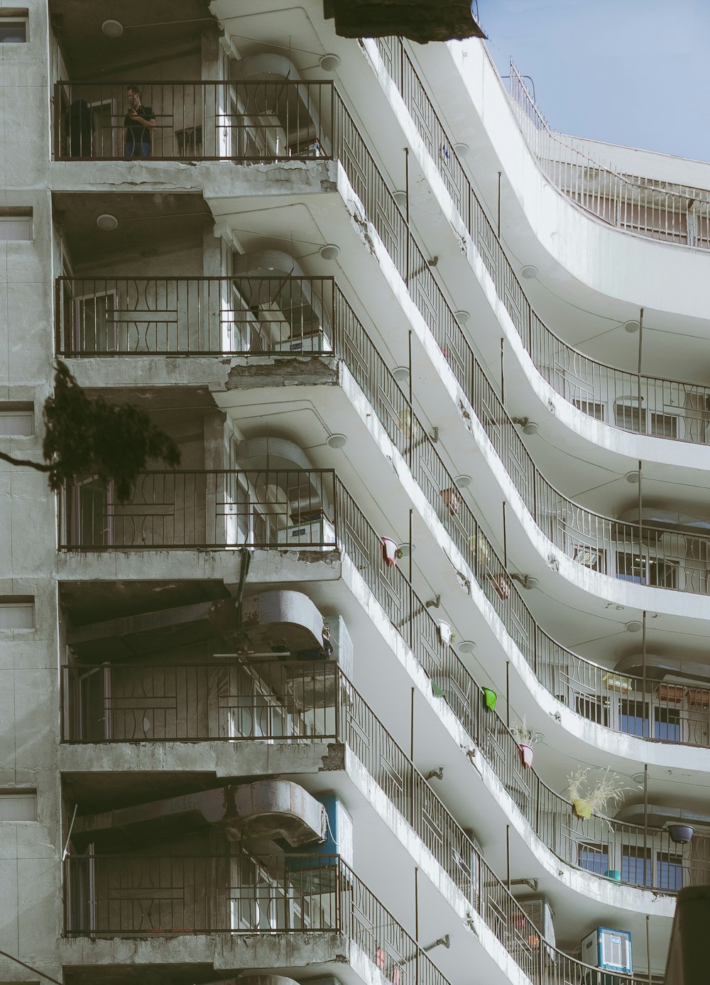 a tall building with a bunch of balconies on it