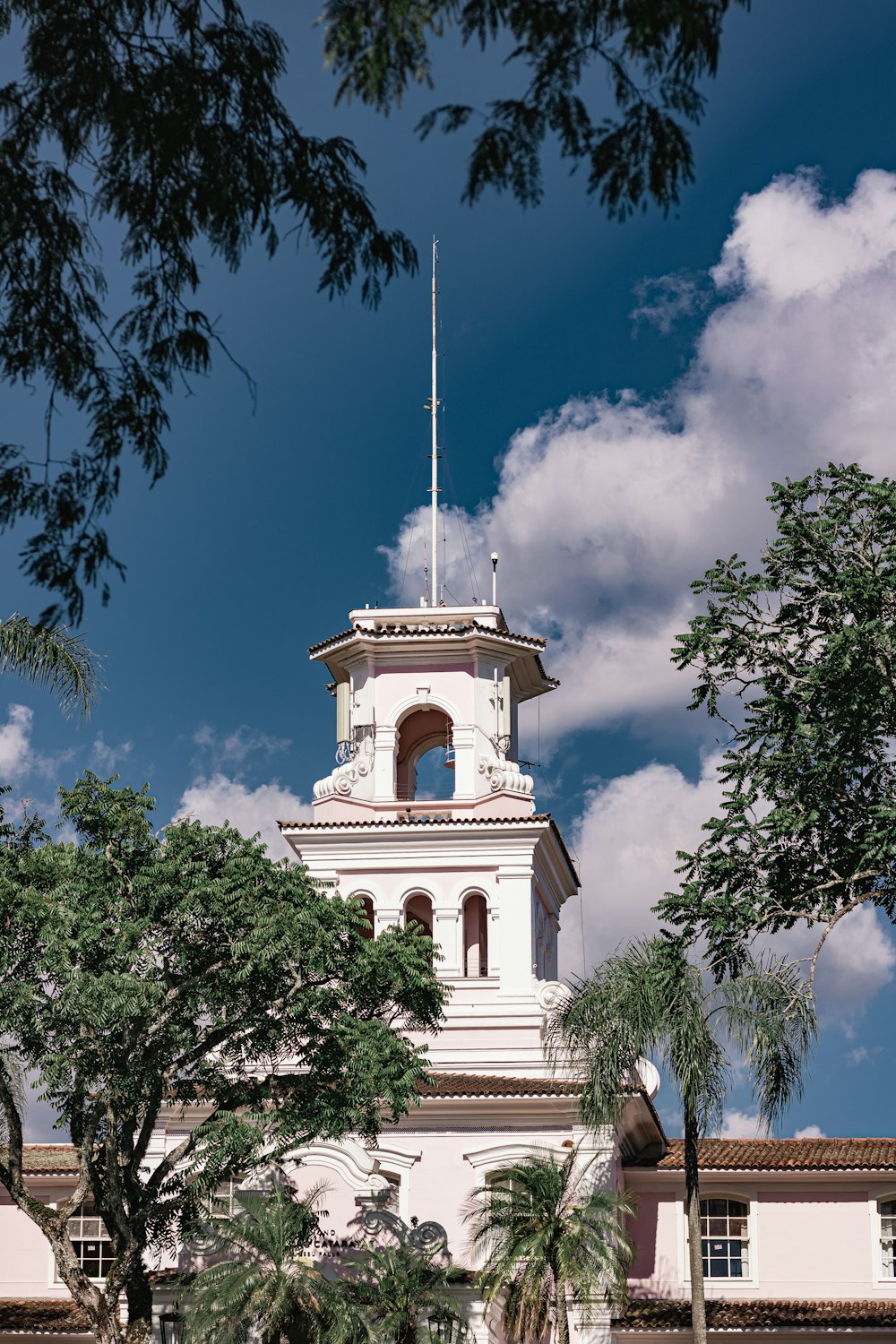 a tall white building with a clock tower