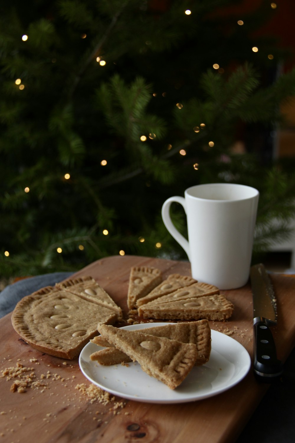 a plate of crackers next to a cup of coffee