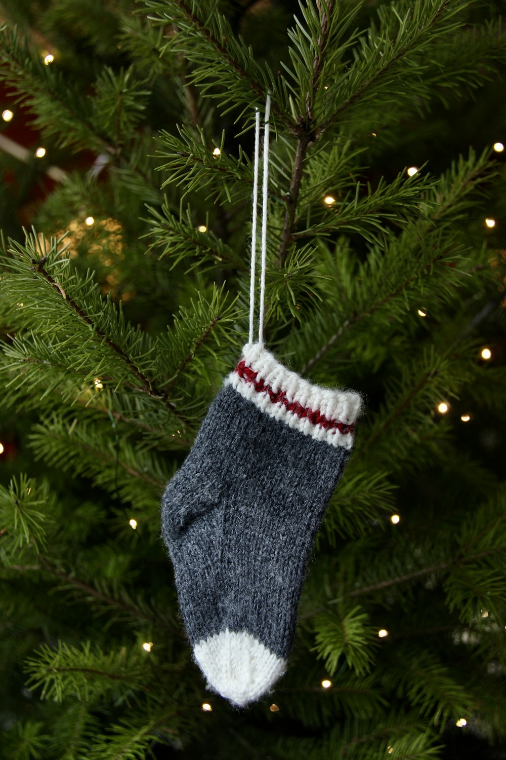 a christmas ornament hanging from a christmas tree