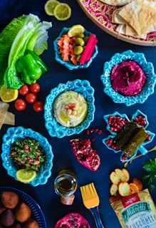 a table topped with plates and bowls of food