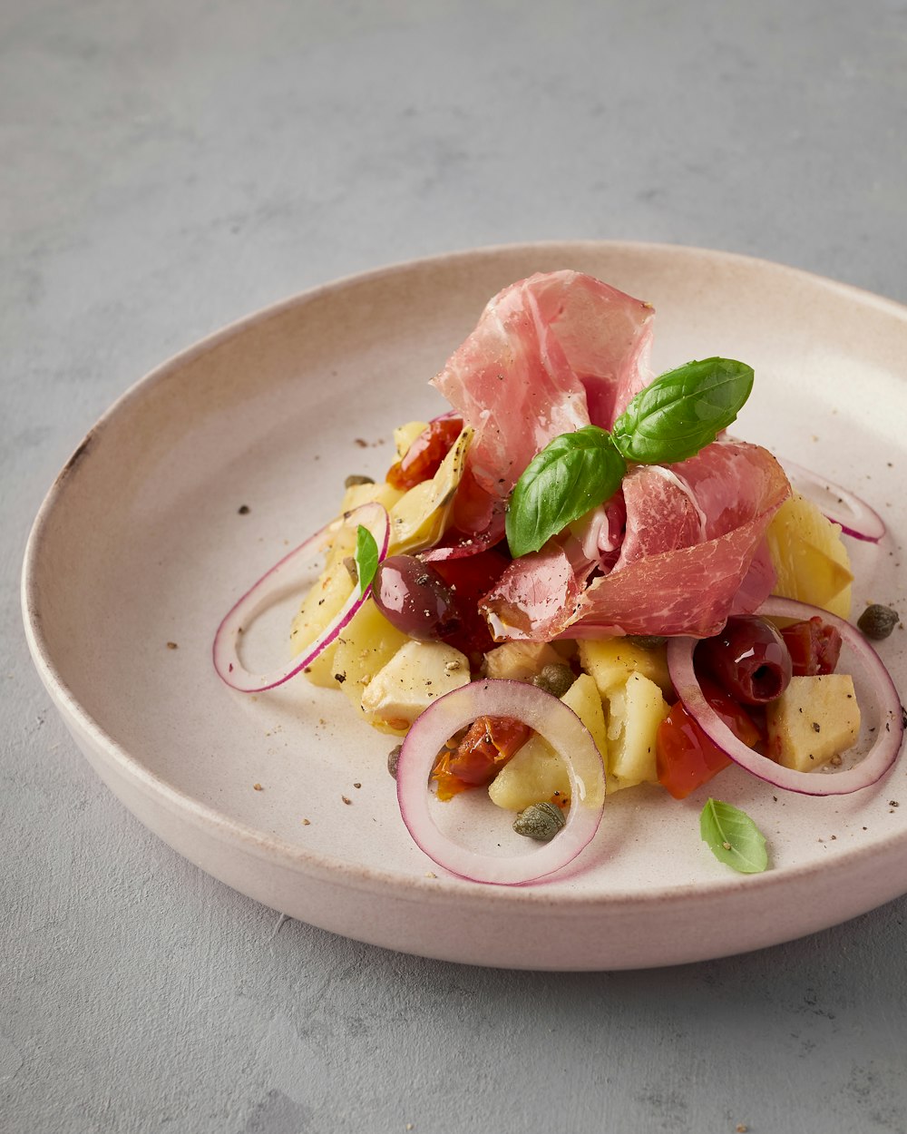 a white plate topped with meat and veggies