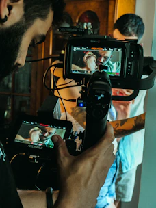 a man holding a camera and recording a video