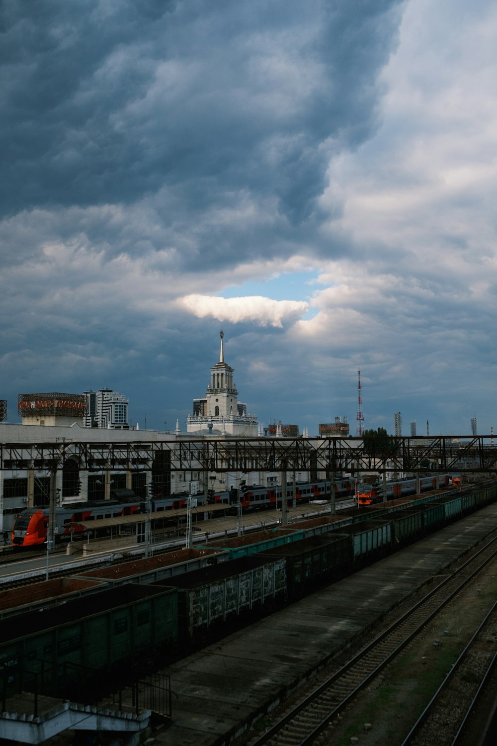 a train station with a cloudy sky in the background