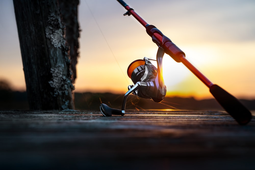 a fishing rod and a reel on the ground