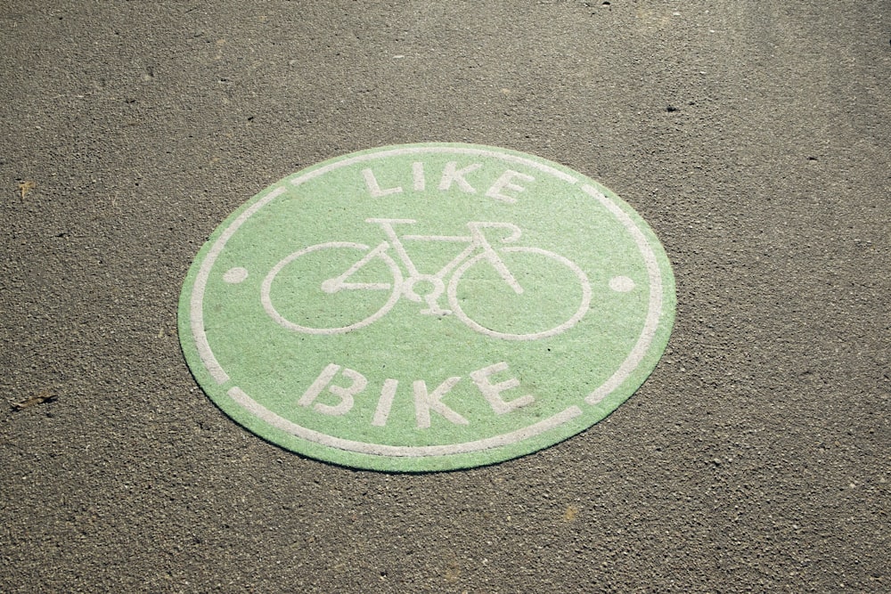 a green bike parking mat with a white bike on it