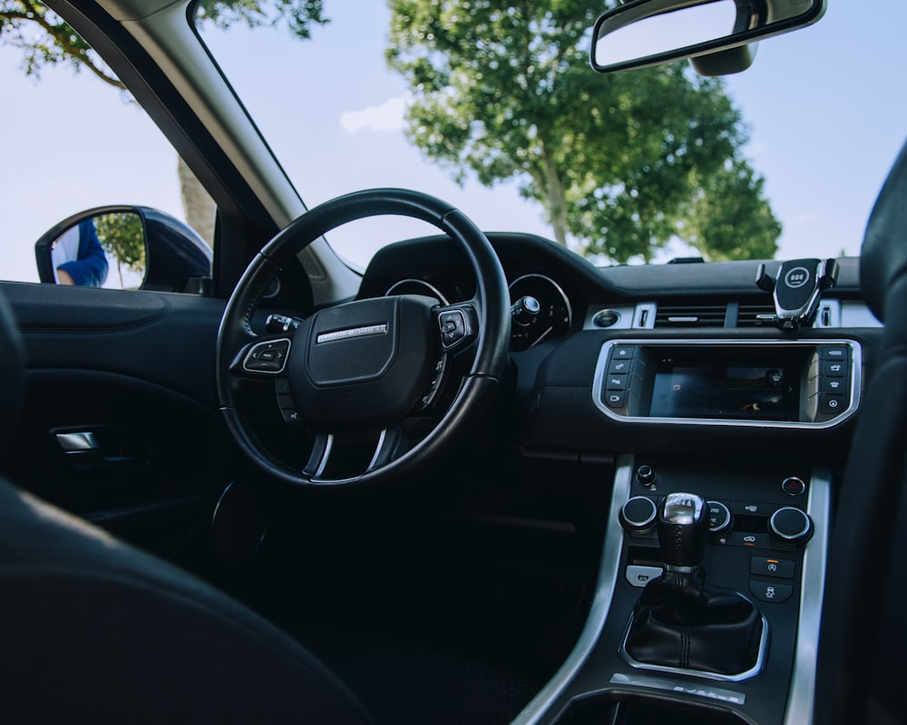 the interior of a car with a steering wheel and dashboard