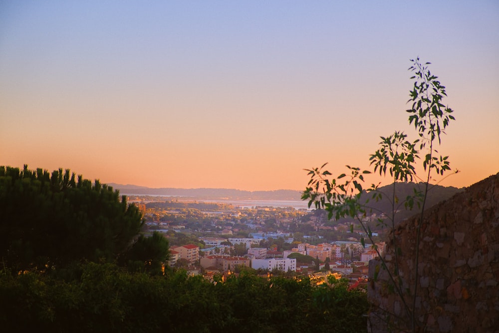 a view of a city at sunset from a hill