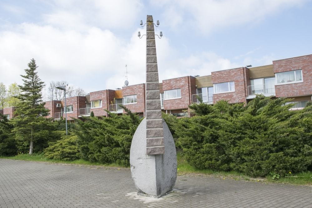 a sculpture in front of a brick building