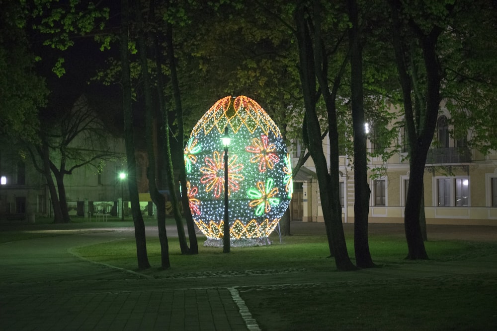 a large lighted ball in the middle of a park