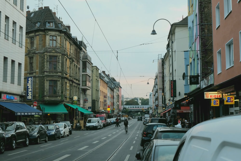 a city street filled with lots of traffic next to tall buildings