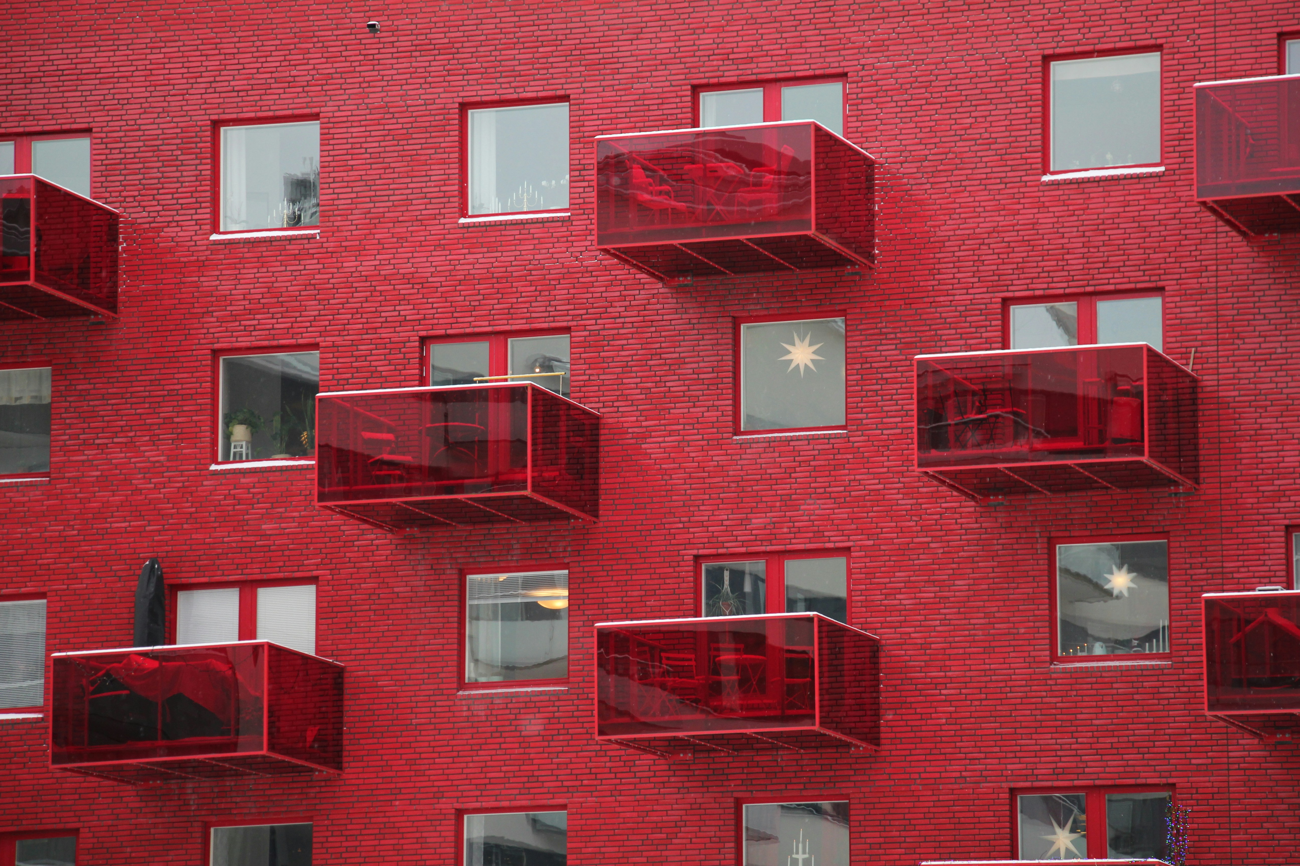 a red building with many windows and balconies