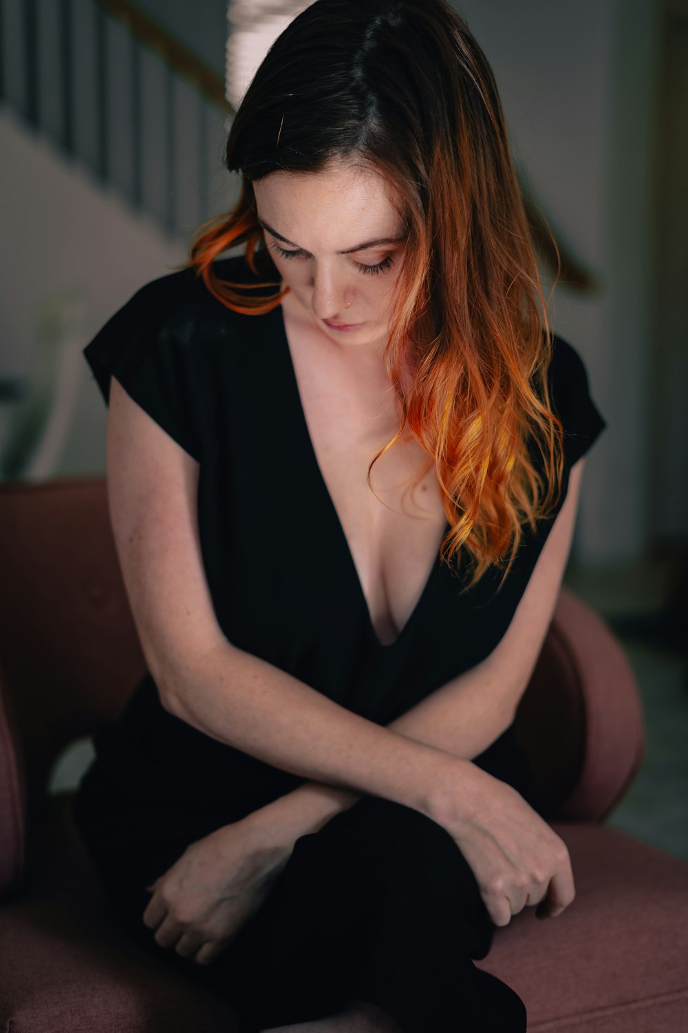 a woman with red hair sitting on a chair