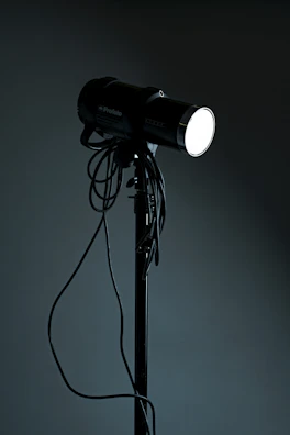 A portable lighting kit glowing warmly in a dim studio.