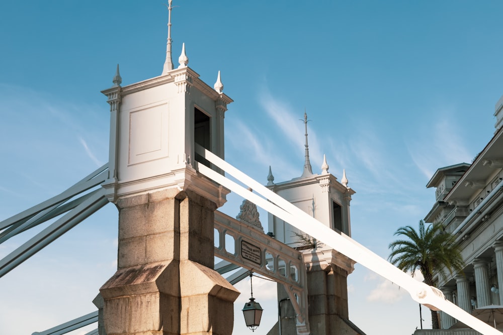 a tall white clock tower sitting next to a tall building