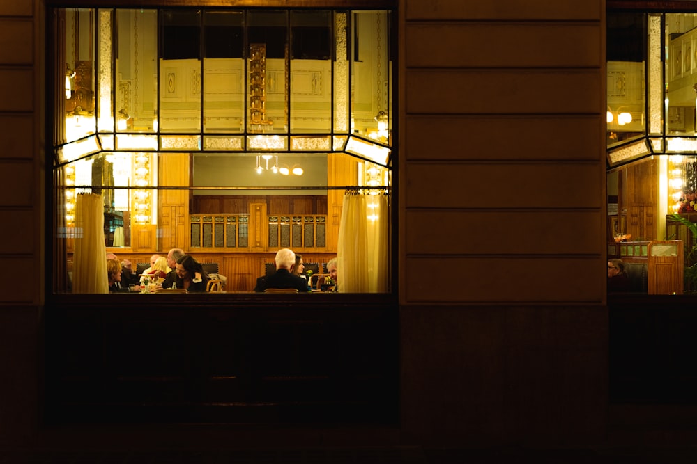 a group of people sitting at a table in a restaurant