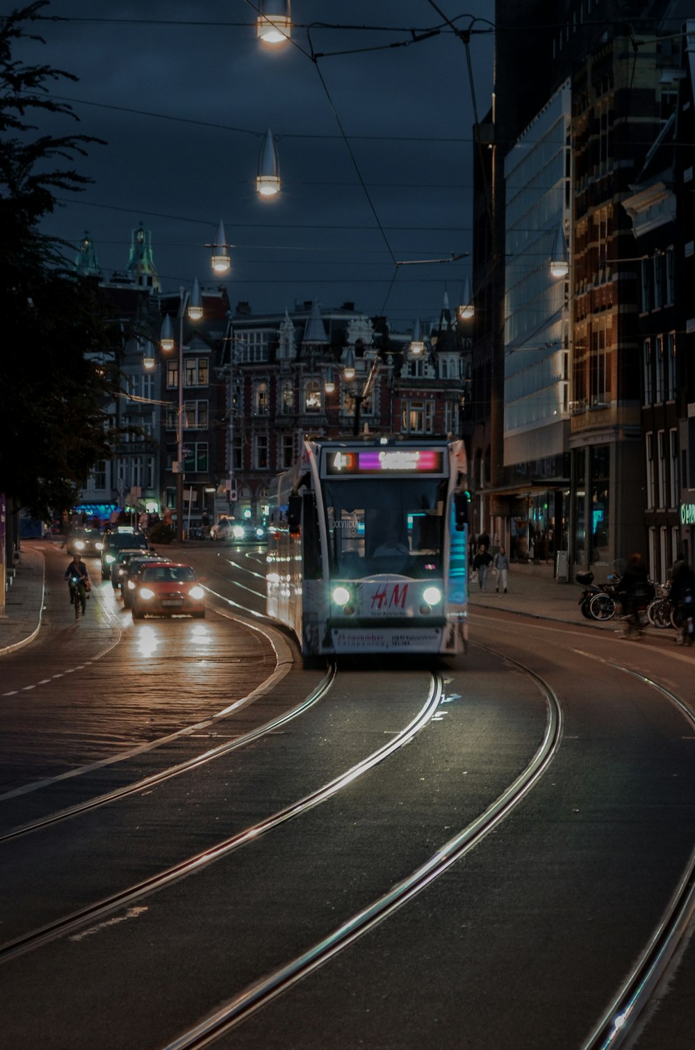 a city bus driving down a street at night
