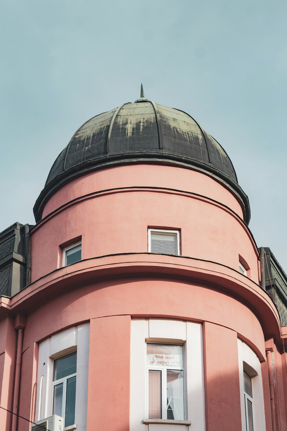 a pink building with a dome on top of it