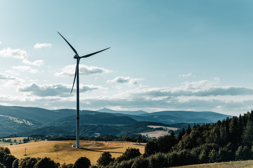 a wind turbine on top of a hill