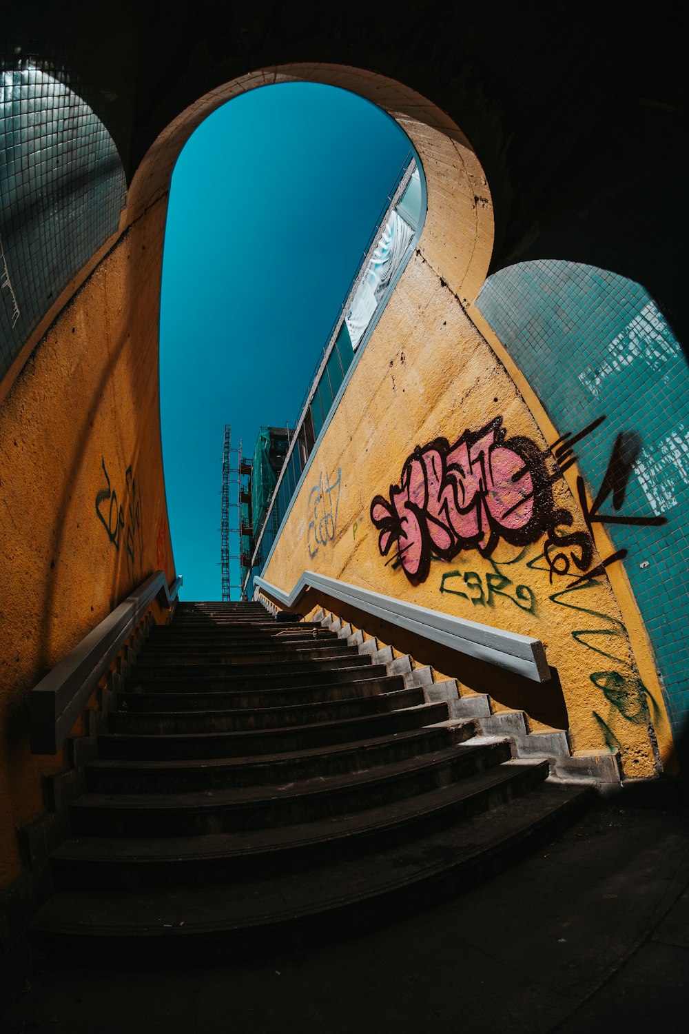 a staircase with graffiti on the side of it