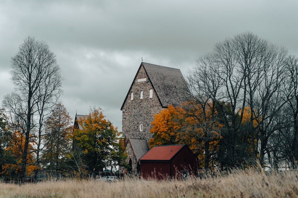 a house with a red roof surrounded by trees