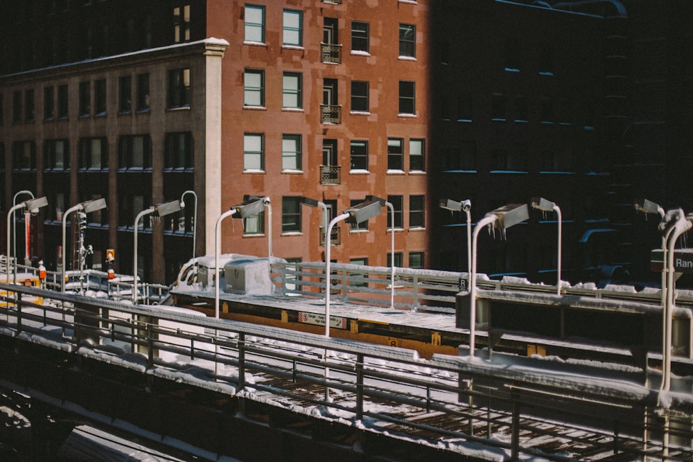 a train traveling down tracks next to a tall building