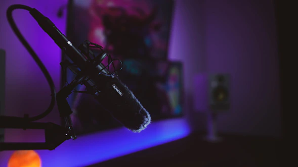 a microphone in front of a purple light