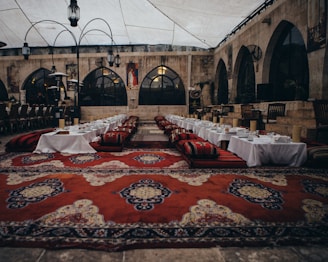a banquet hall with a red carpet and tables