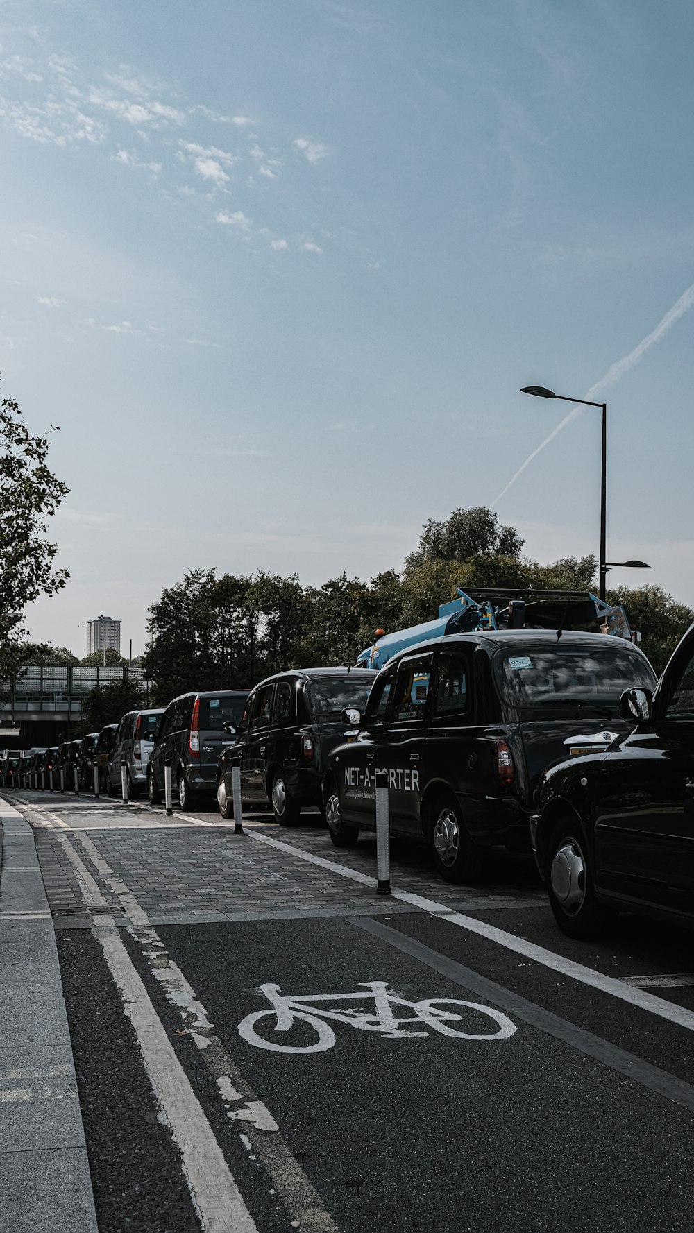 a line of cars parked on the side of a road