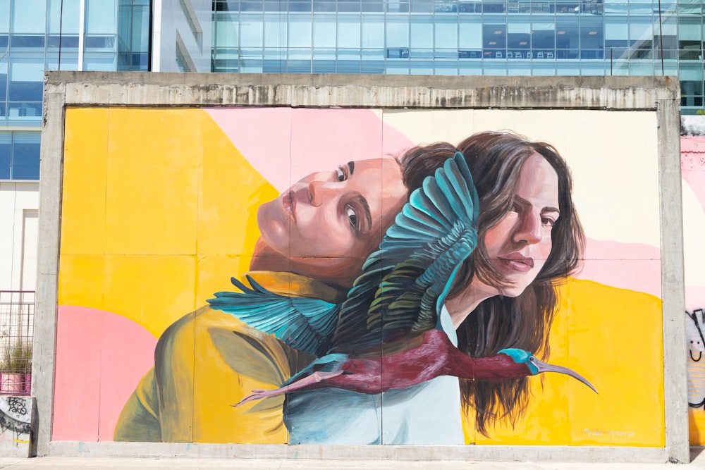 a large mural of two people and a bird