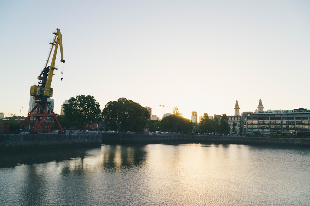 a crane is on the side of a body of water,