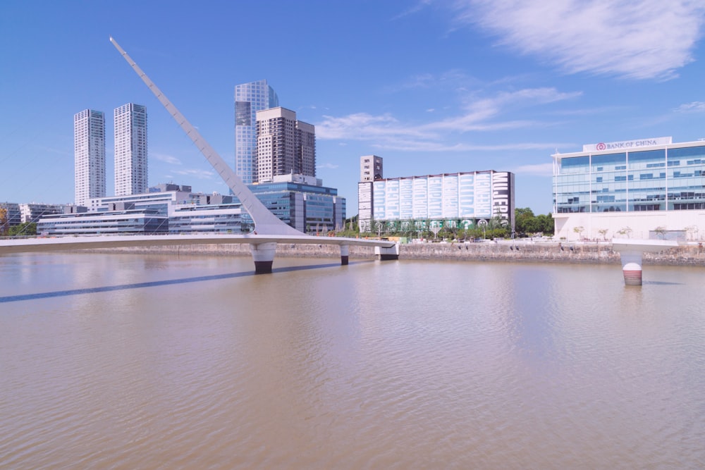 a large body of water with buildings in the background