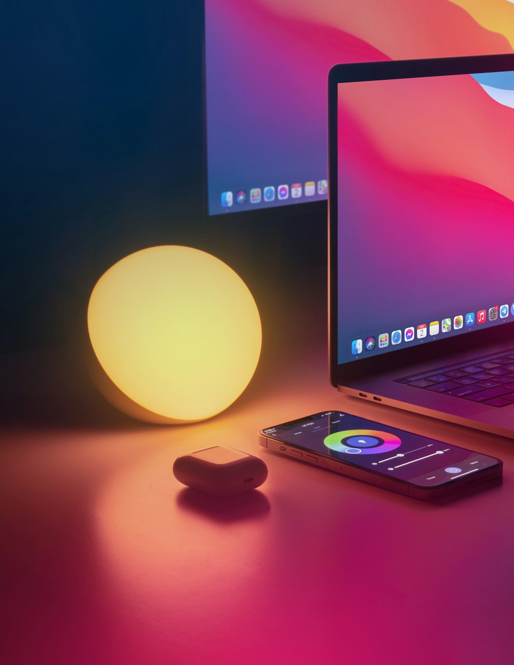 a laptop computer sitting on top of a desk next to a mouse