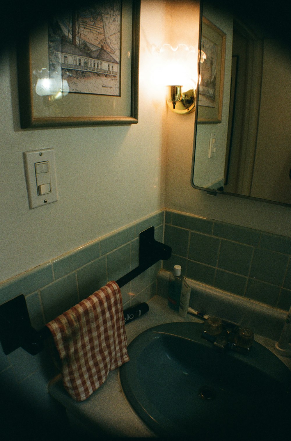 a bathroom sink with a towel hanging on the wall