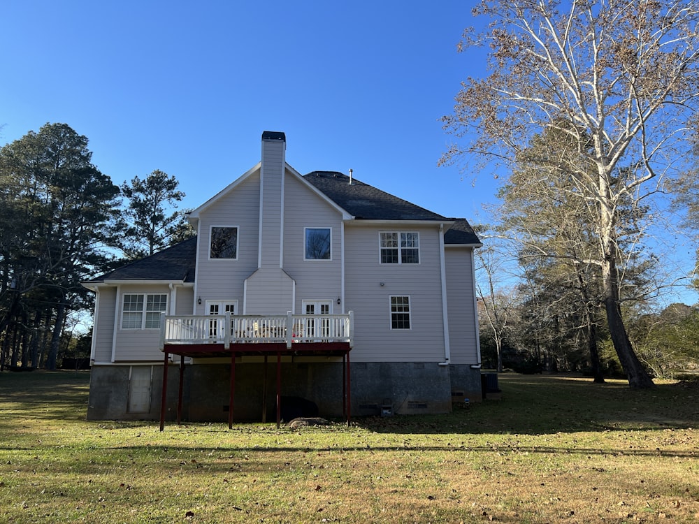 a white house with a porch and a covered porch