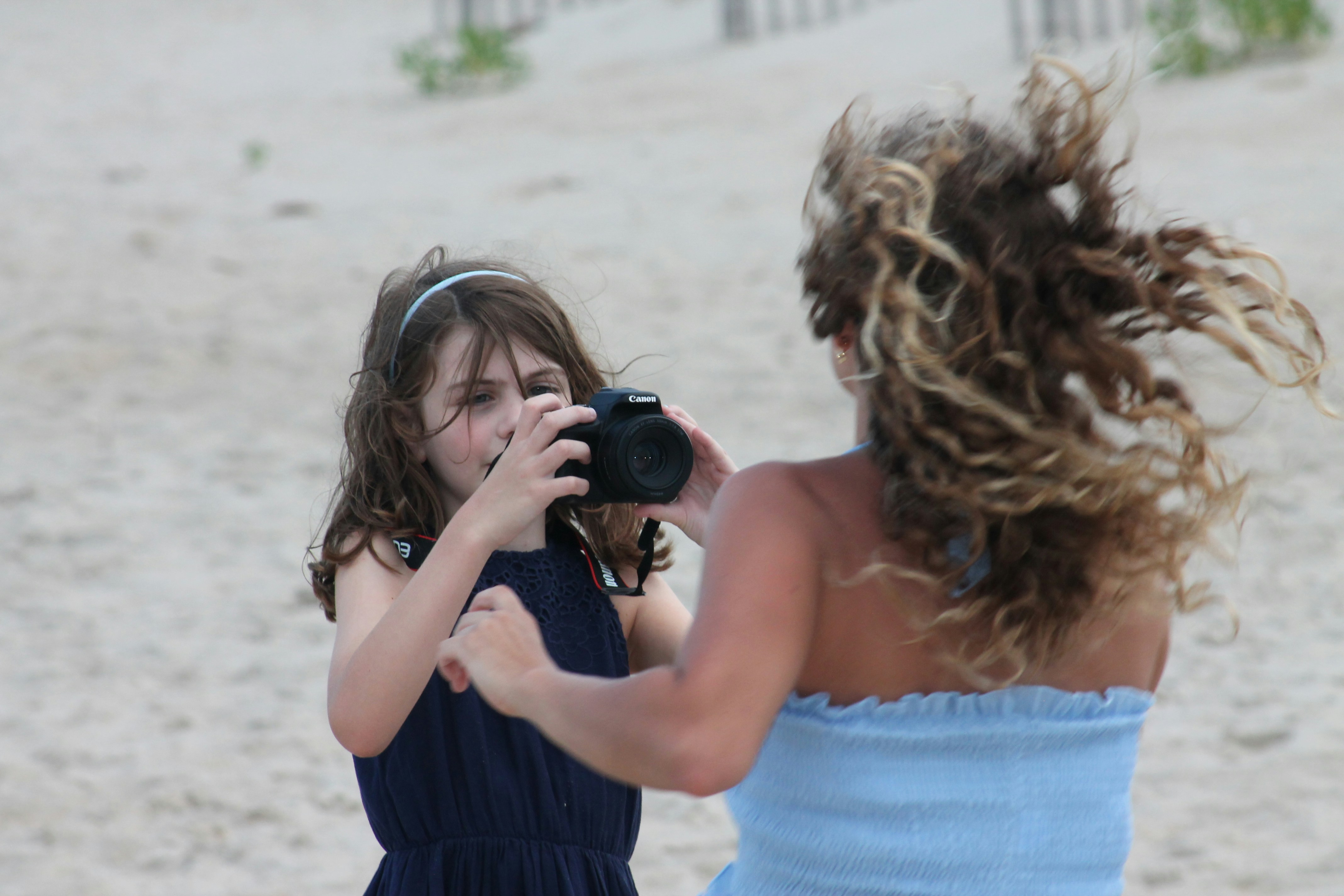 Mom photographing kids at beach