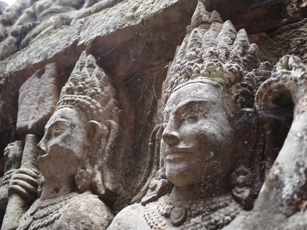 a close up of some statues on a wall