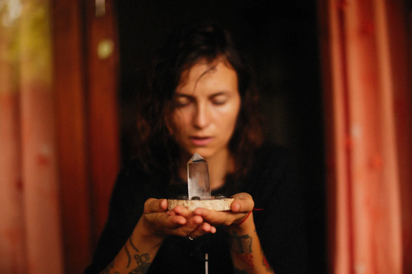 a woman holding a crystal in her hands