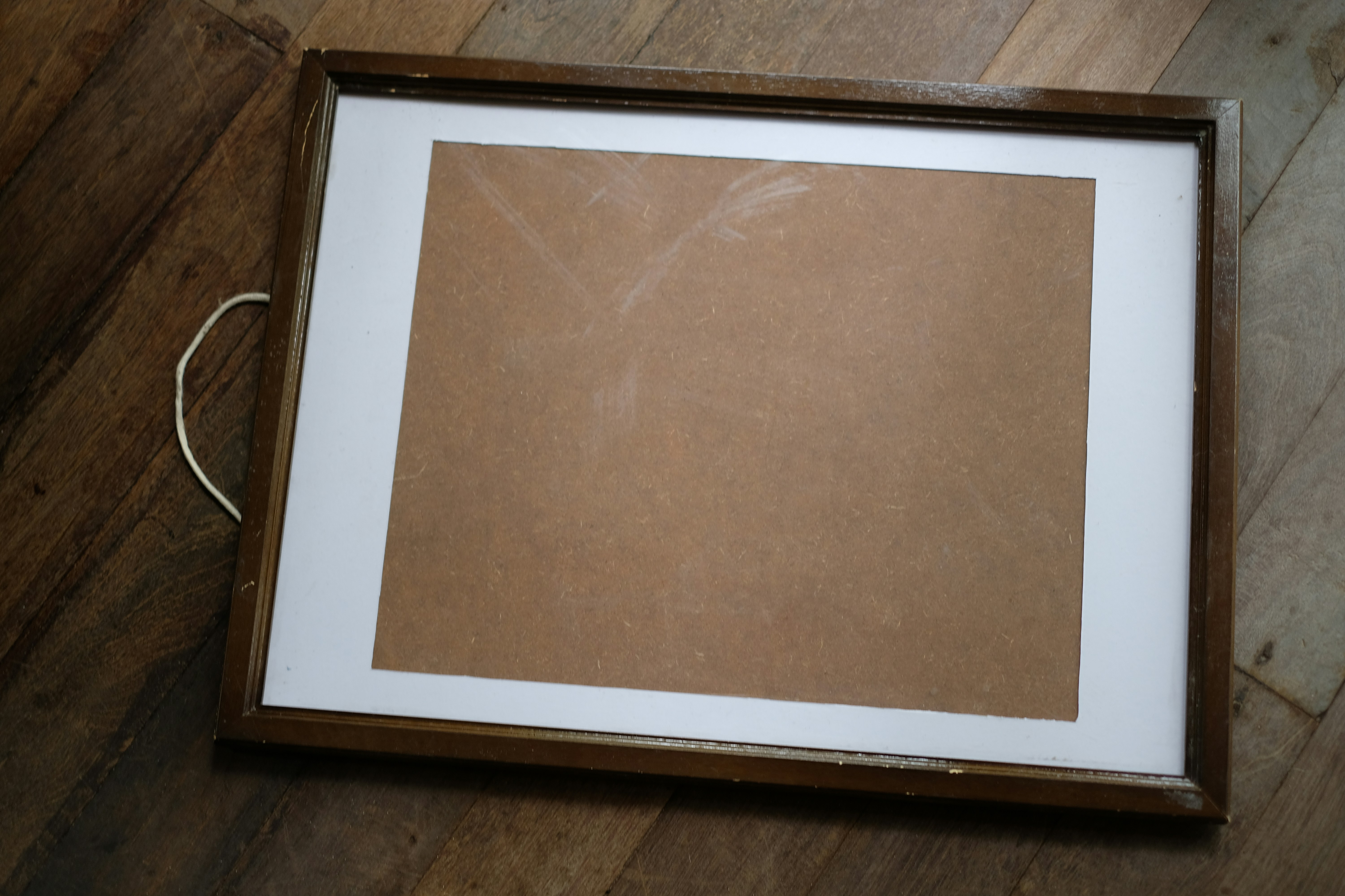 A picture frame sitting on top of a wooden floor