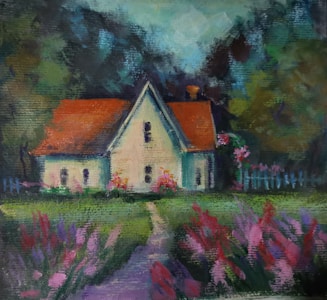 A picturesque rural house with a triangular roof and bright orange tiles, surrounded by vibrant flower beds in shades of pink and purple. A path leads from the foreground towards the house, lined with lush green grass. Tall trees frame the scene, adding depth and a sense of seclusion.