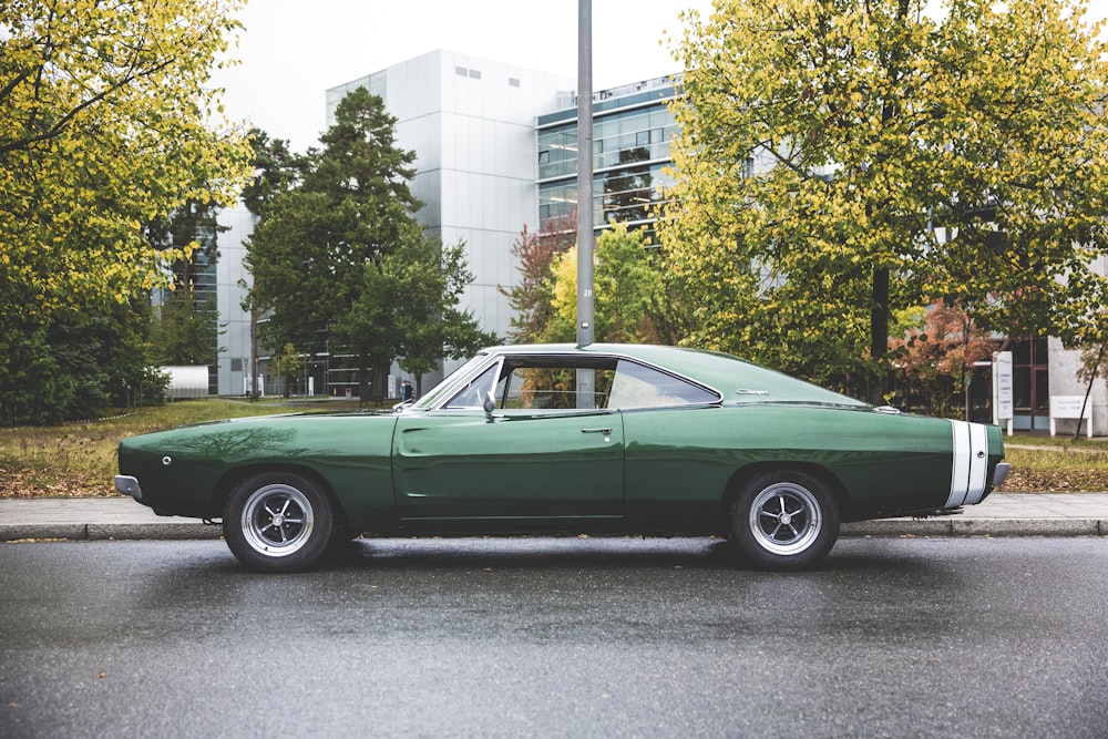 a green car parked on the side of the road