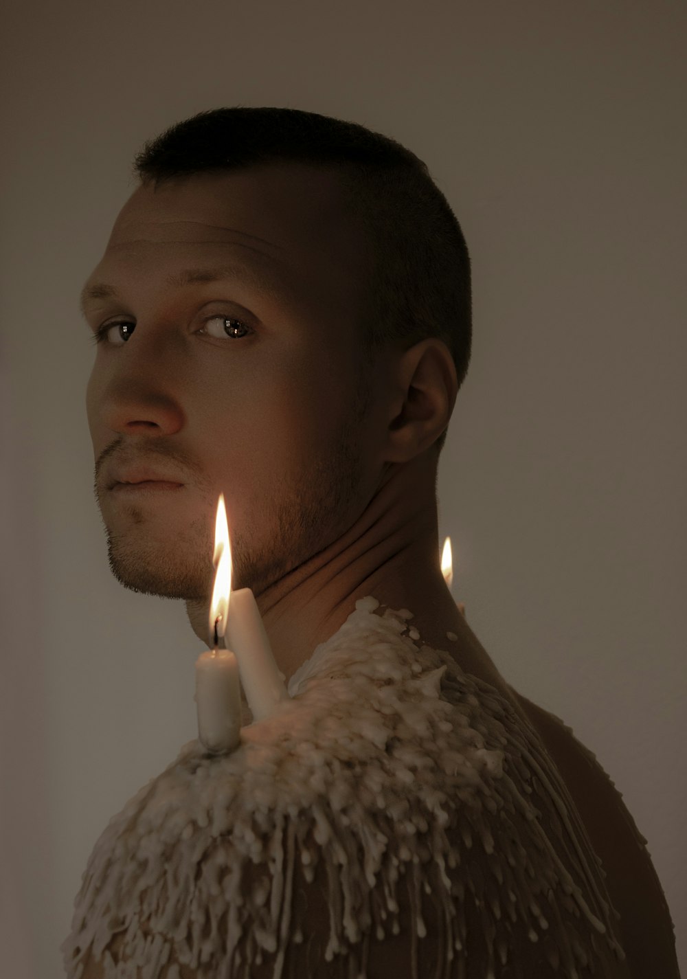 a man with a candle in his neck