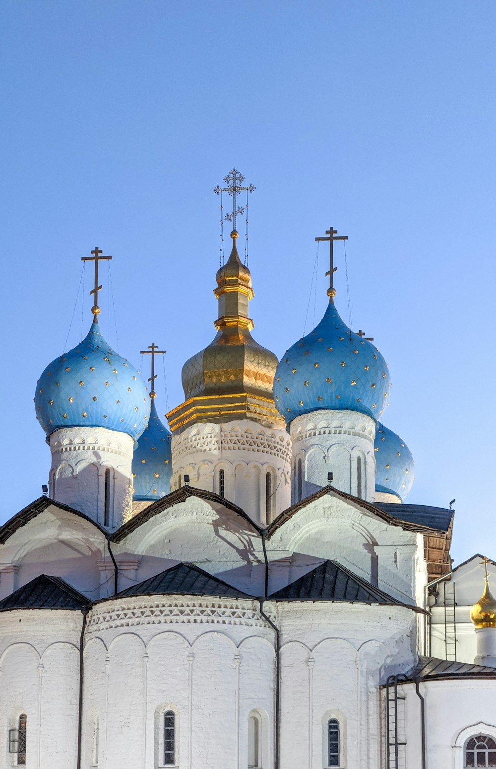a large white building with blue and gold domes